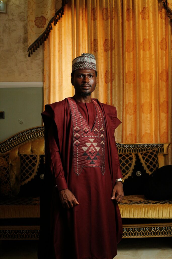 Elegant man wearing agbada in Abuja, showcasing traditional Nigerian fashion.